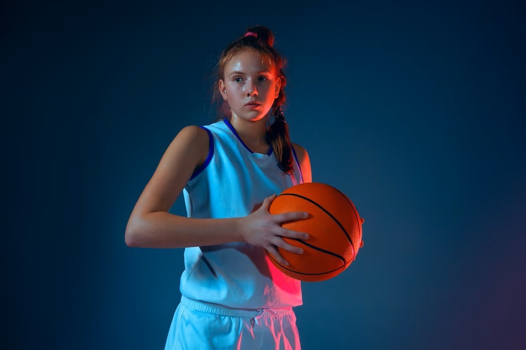 https://weareallinhoops.com/wp-content/uploads/2023/06/young-female-basketball-player-blue.jpg
